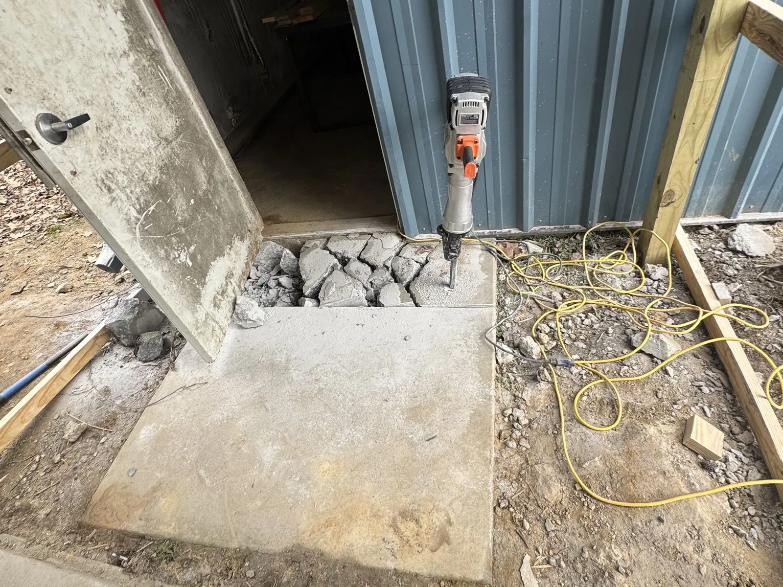 Shed entrance before concrete pad, broken concrete